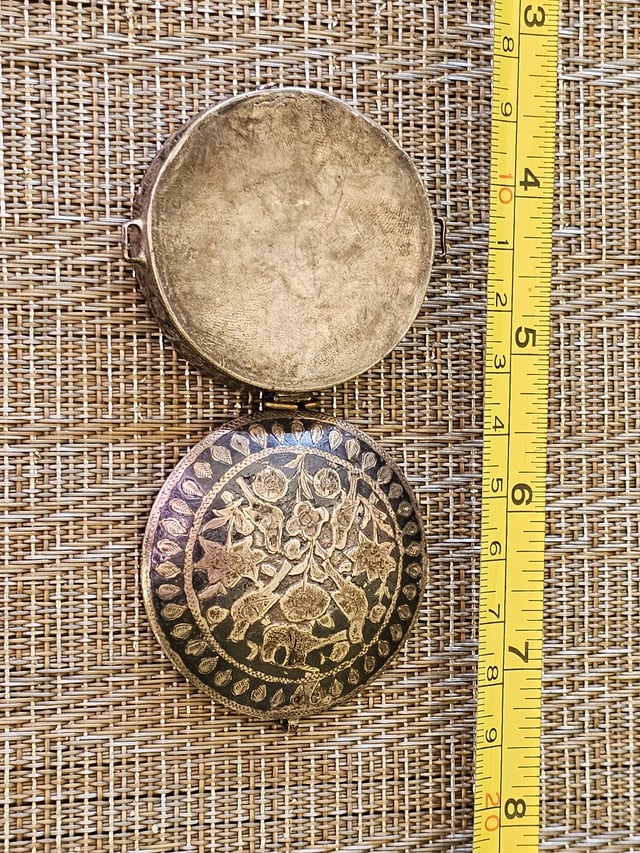 r/whatisthisthing - Small, 2.5 cm, silver case/box. I have had it at least 50 years and I have never known what it is. Possible hematite inlay on the lid and sides that looks worn. Hinge is just a brass loop. Clasp is broken. Small handle on each side. Long story as to how I got this thing.